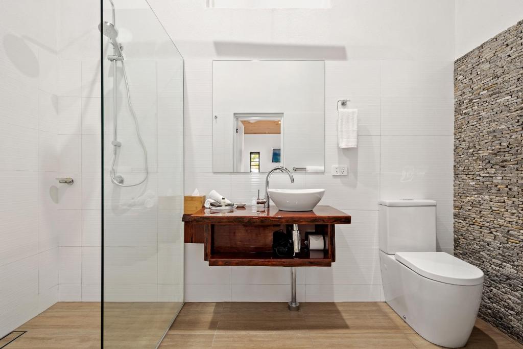 Modern bathroom at Freedom Shores Resort featuring a walk-in shower and stylish wooden vanity.