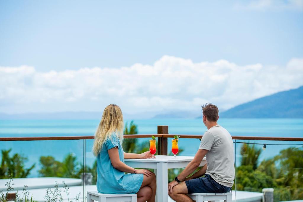 Couple enjoying cocktails with stunning ocean views at Freedom Shores Resort in Airlie Beach